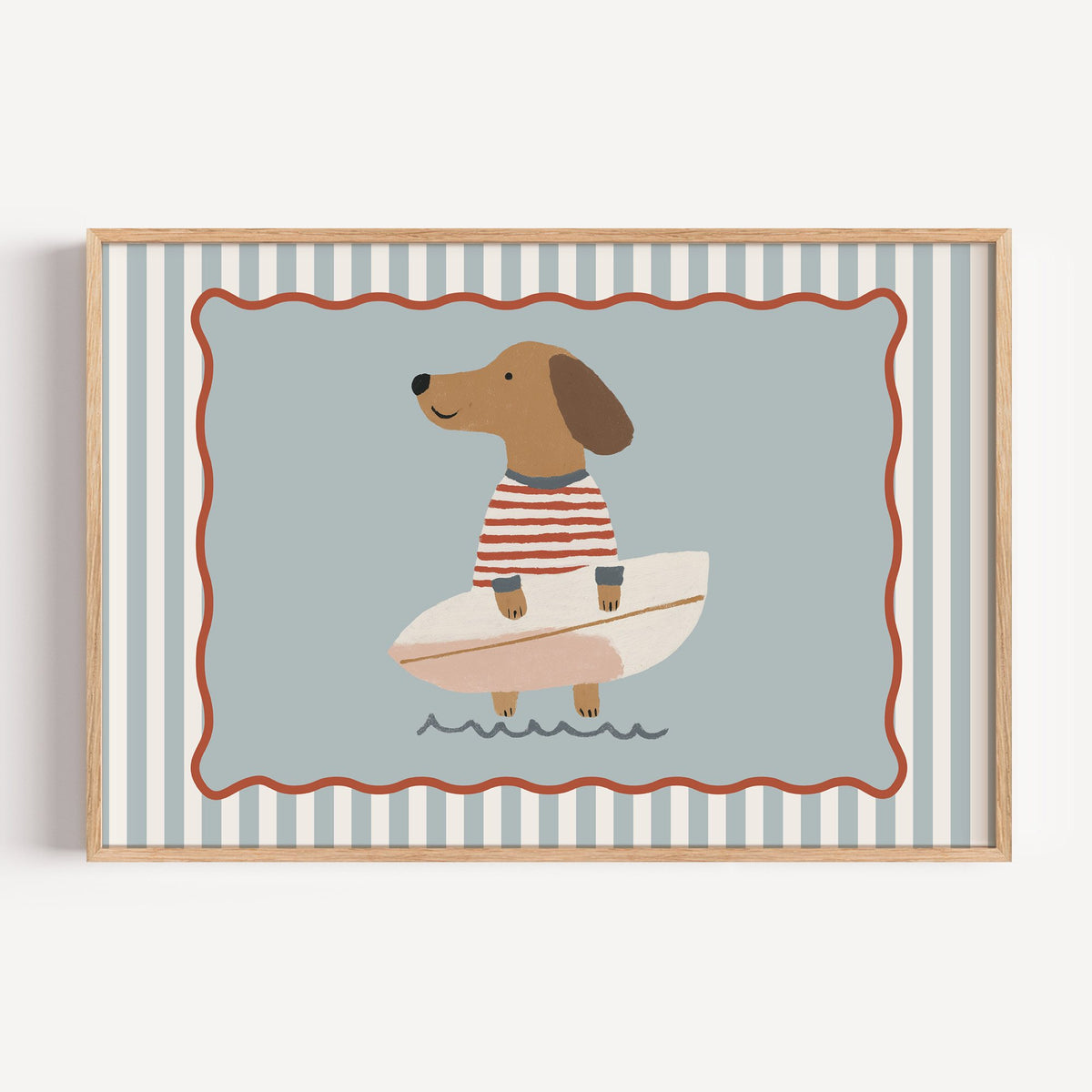 Landscape dachshund holding surfboard nursery print in a light oak frame on a plain white wall