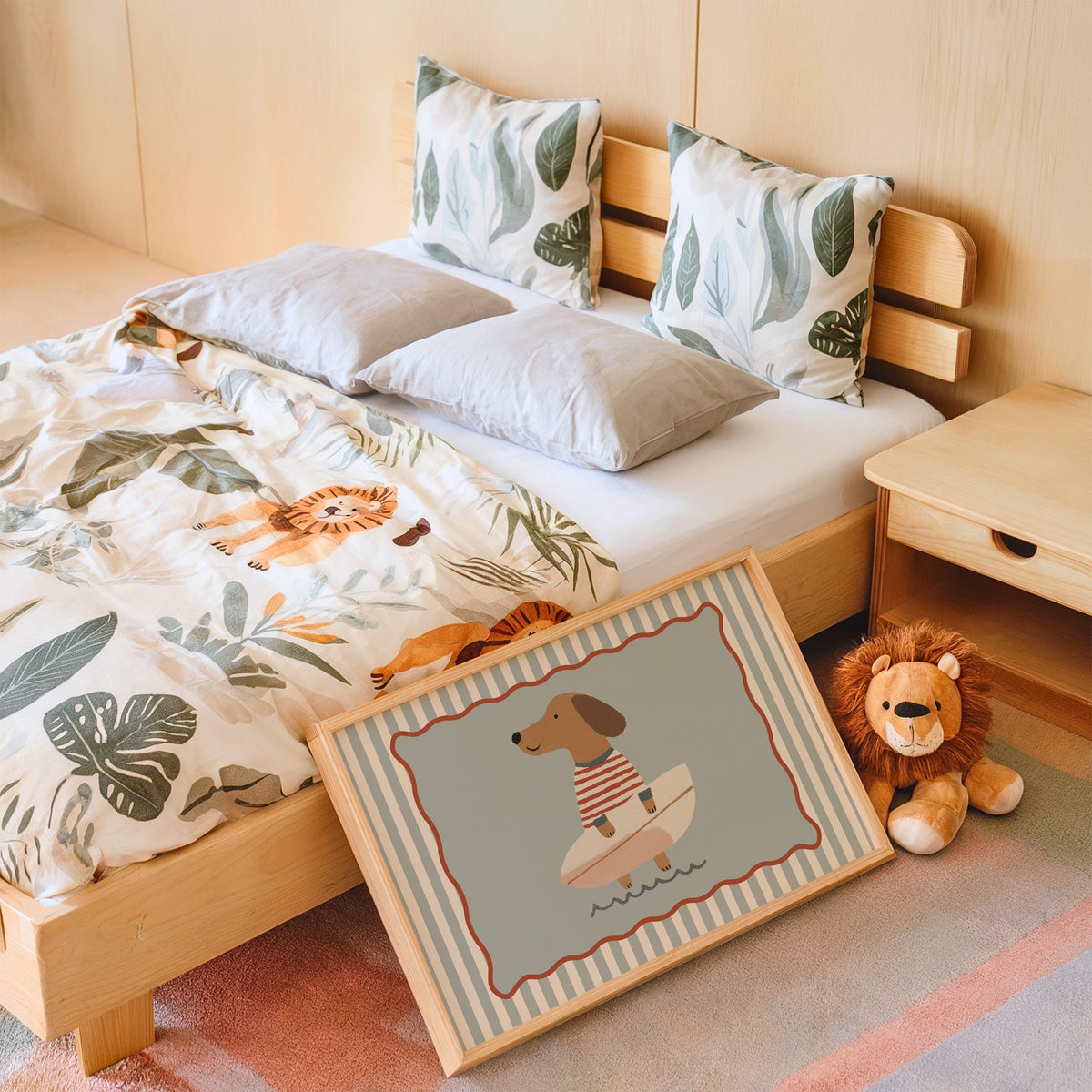 Landscape dachshund holding surfboard nursery print in an oak frame leaning on a kids bed by a lion plush