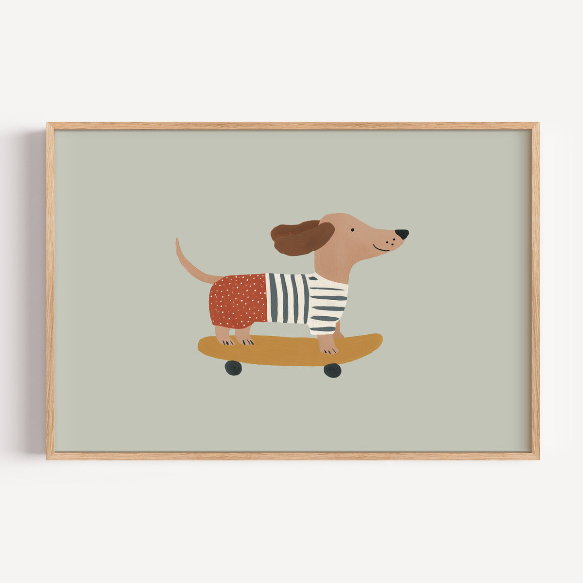 Landscape dachshund skateboard sage nursery print in a light oak frame on a plain white wall