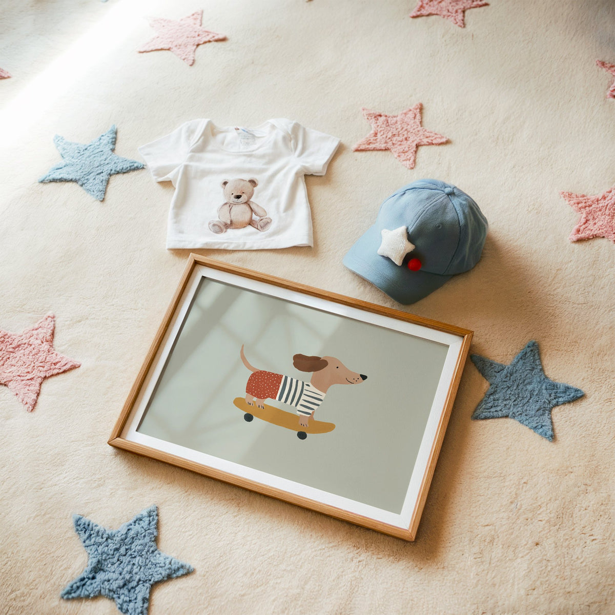 Landscape dachshund skateboard sage nursery print in a matted oak frame on a star rug with a baby tee