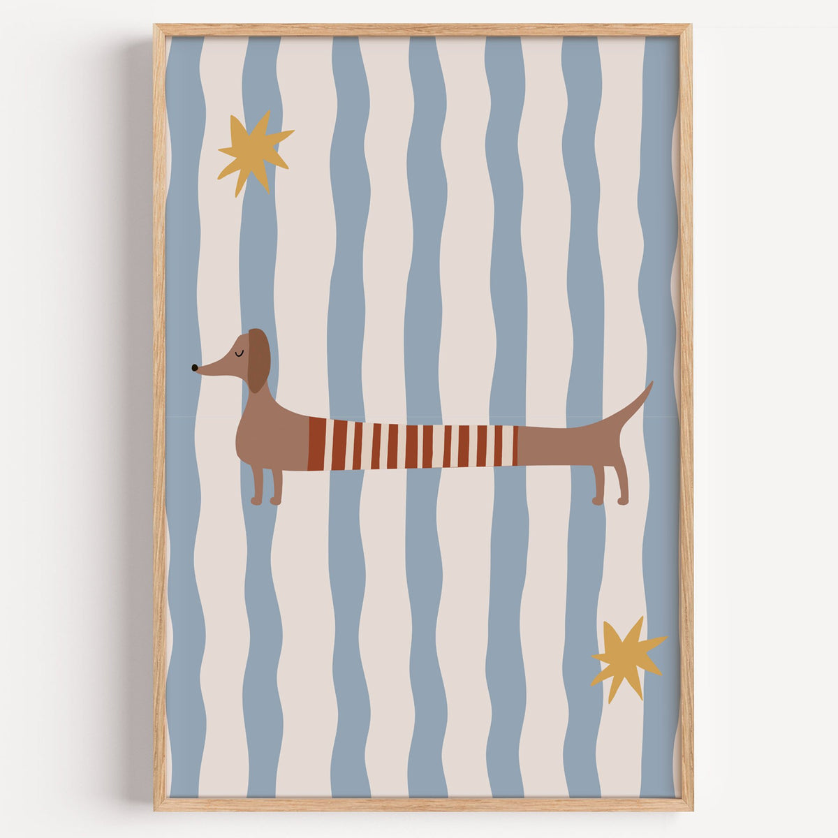Dachshund red striped sweater nursery print in a light oak frame on a plain white wall