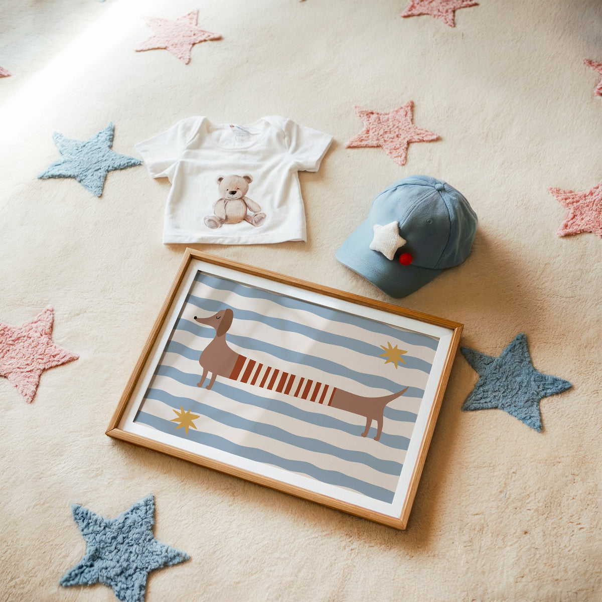 Landscape dachshund red striped sweater nursery print in a matted oak frame on a star rug with a baby tee