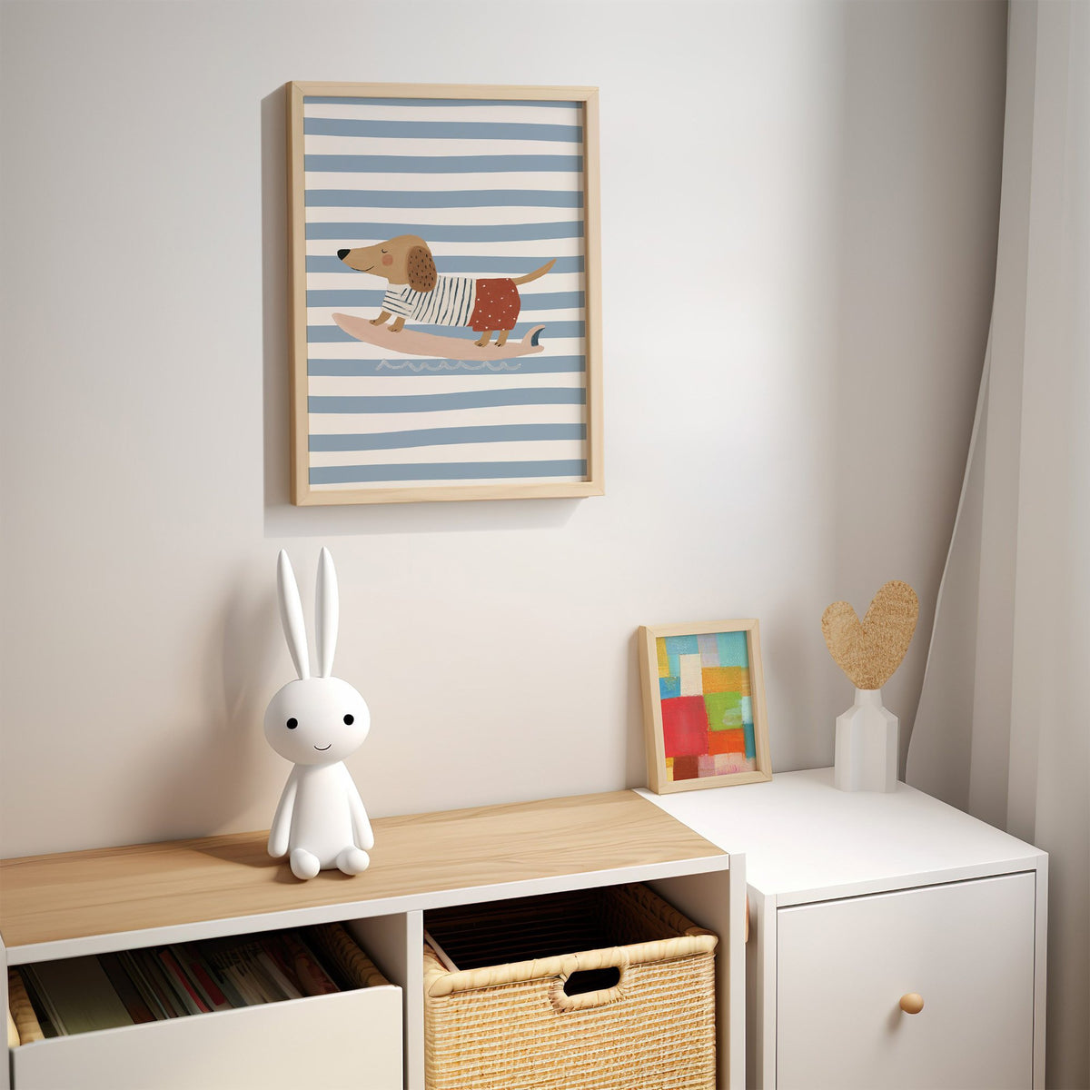 Dachshund on pink surfboard nursery print in an oak frame above a kids cubby shelf with a woven basket and bunny lamp