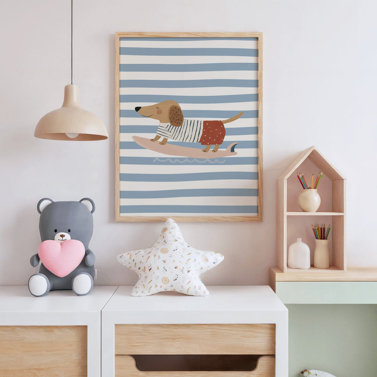 Dachshund on pink surfboard nursery print in an oak frame above a white dresser with a star pillow and house shelf