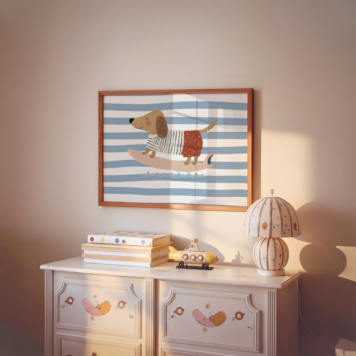 Landscape dachshund on pink surfboard nursery print in a cherry wood frame above a painted dresser and lamp