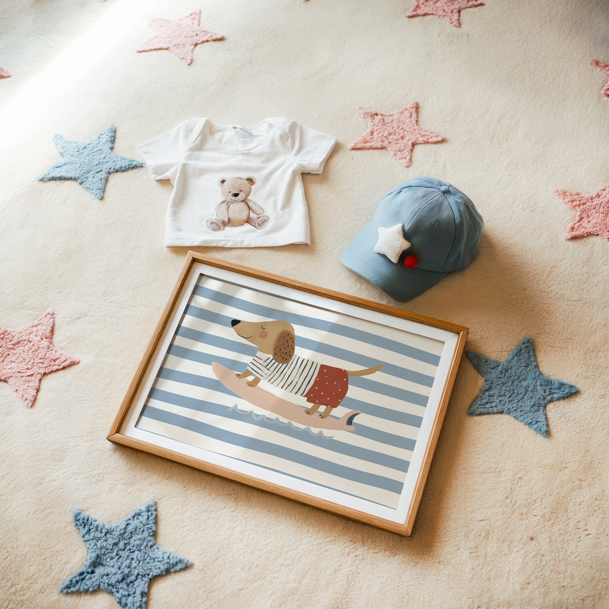 Landscape dachshund on pink surfboard nursery print in a matted oak frame on a star rug with a baby tee