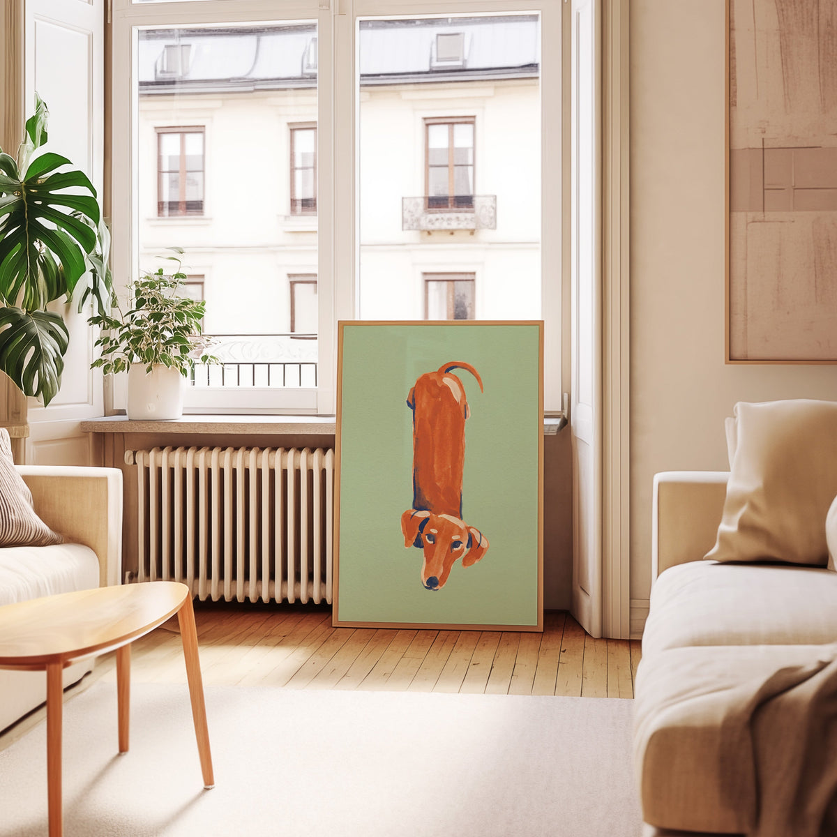 Mint green dachshund print in an oak frame leaning below tall French windows