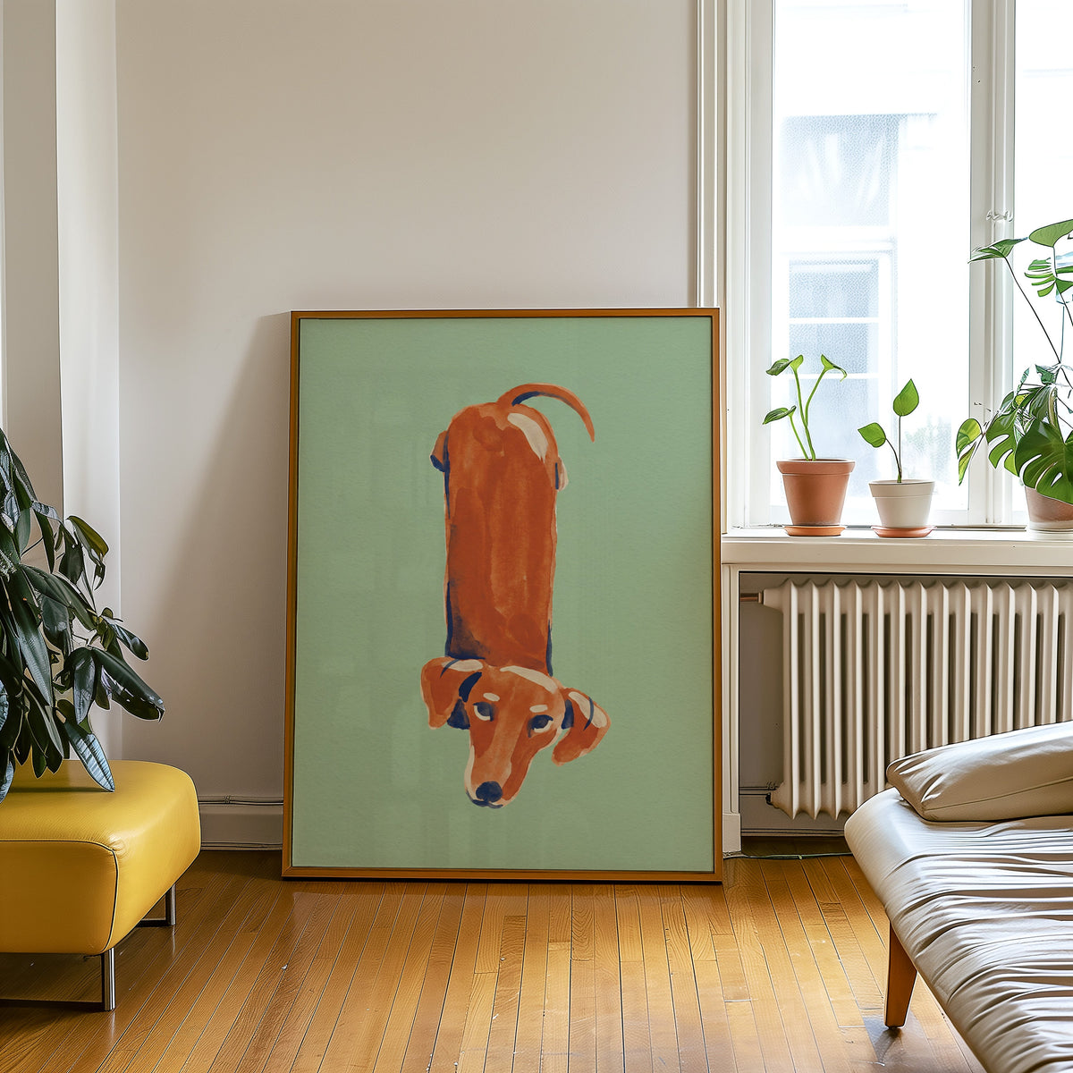 Top-down dog print in an oak frame leaning beside a yellow leather bench