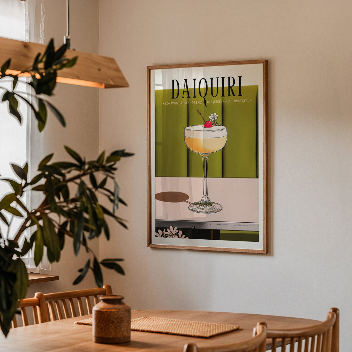 Daiquiri recipe print in a walnut frame above a dining table with olive branches