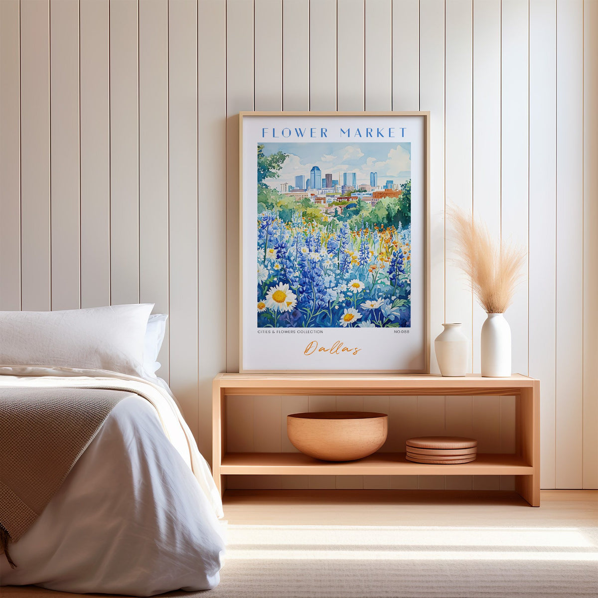 Dallas flower market print in an oak frame on a wood bench against a white shiplap bedroom wall with pampas grass