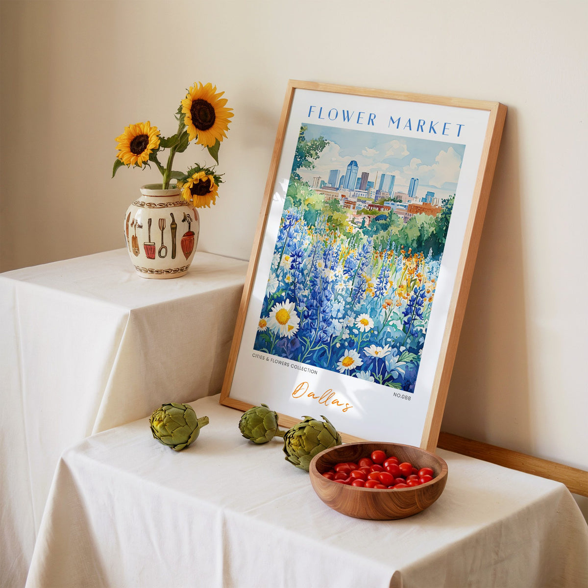 Dallas flower market print in an oak frame leaning on a linen-draped table beside a vase of sunflowers