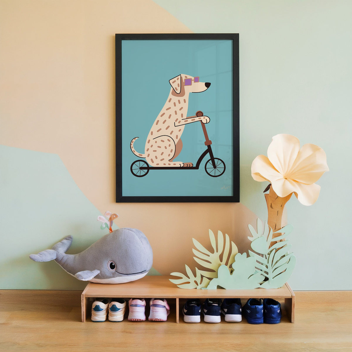 Dalmatian on scooter with purple glasses nursery print in a black frame on a mint and peach wall above a whale plush