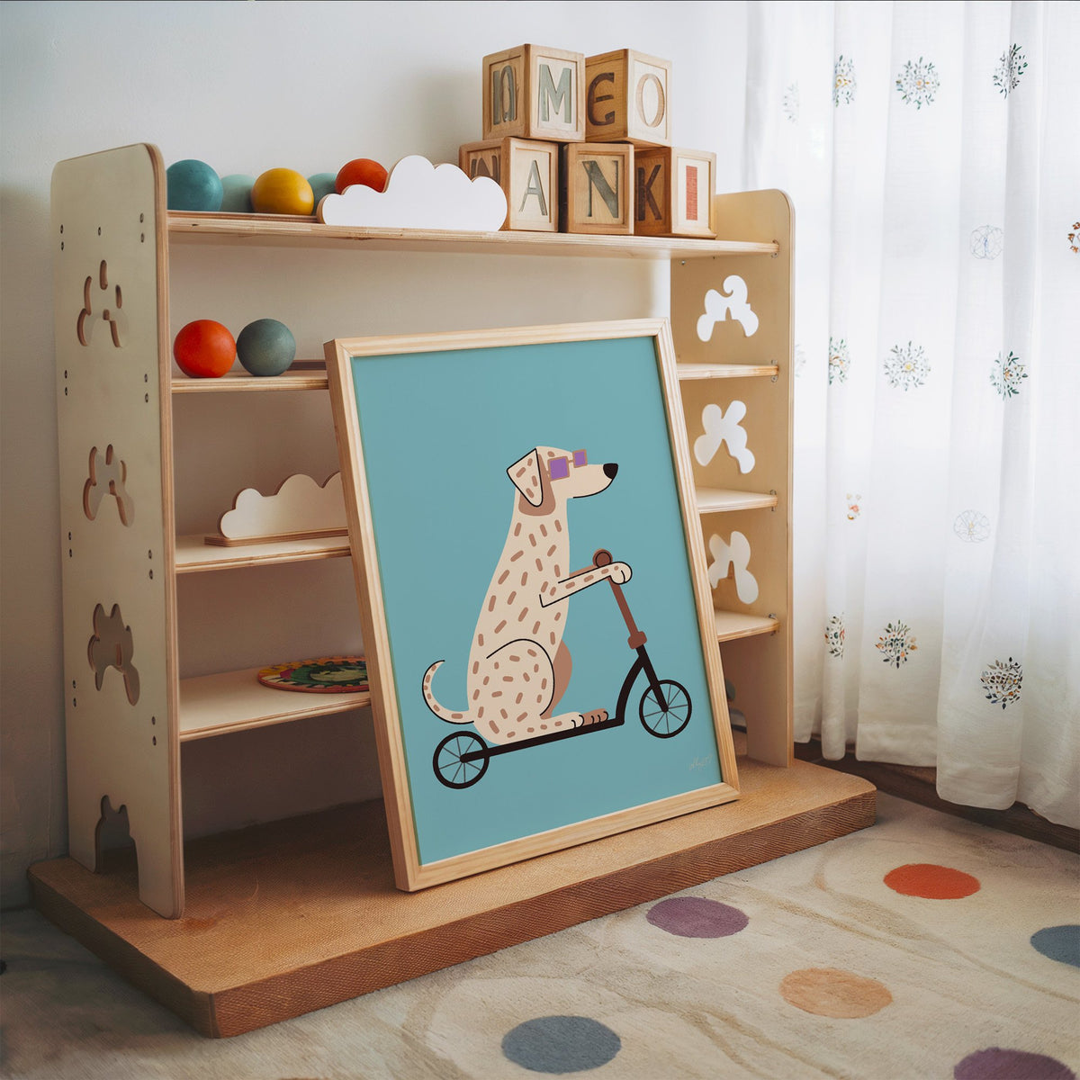Dalmatian on scooter with purple glasses nursery print in an oak frame leaning on a toy shelf with wooden letter blocks
