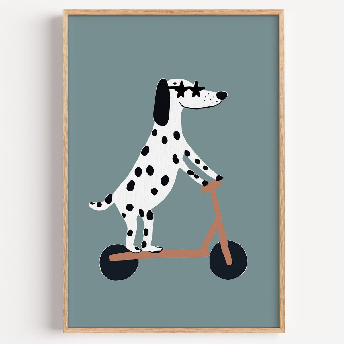 Dalmatian on scooter star glasses nursery print in a light oak frame on a plain white wall