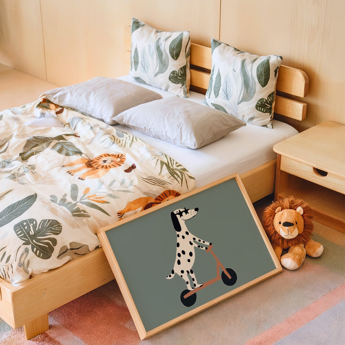 Landscape dalmatian on scooter star glasses nursery print in an oak frame leaning on a kids bed by a lion plush