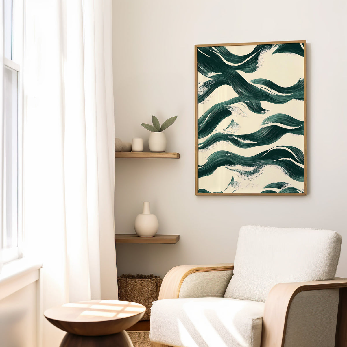 Dark green brushstroke waves abstract print in a slim oak frame above a cream boucle armchair by floating shelves