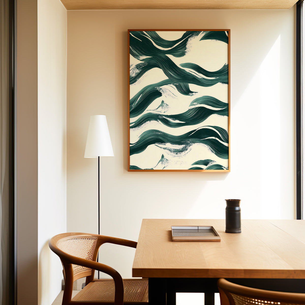 Dark green brushstroke waves abstract print in a slim oak frame above a dining table with a cane-back chair