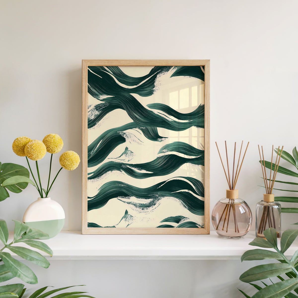Dark green brushstroke waves abstract print in a light oak frame leaning on a white mantel with yellow flowers