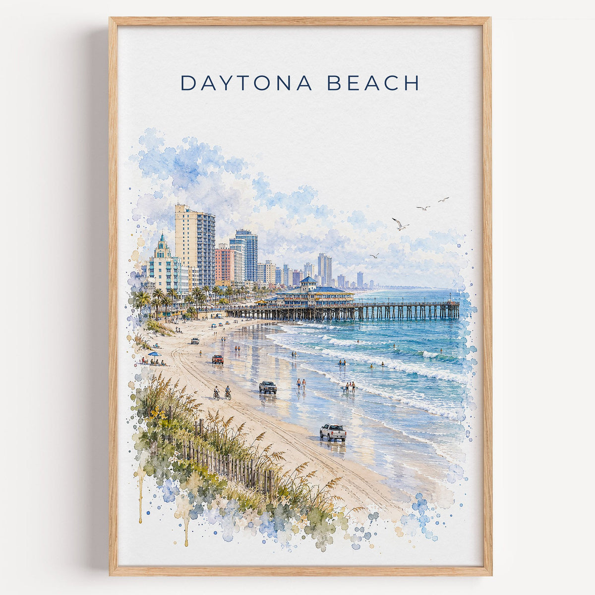 Daytona Beach watercolor print in a light oak frame on a plain white wall