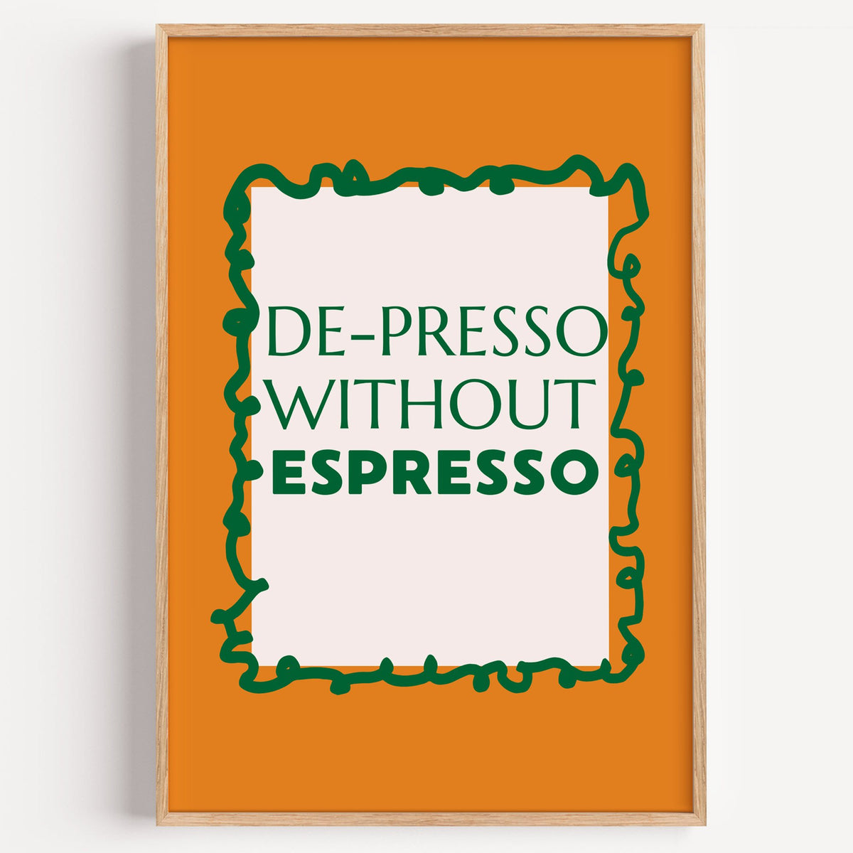 DE-PRESSO WITHOUT ESPRESSO type print in a light oak frame on a plain white wall