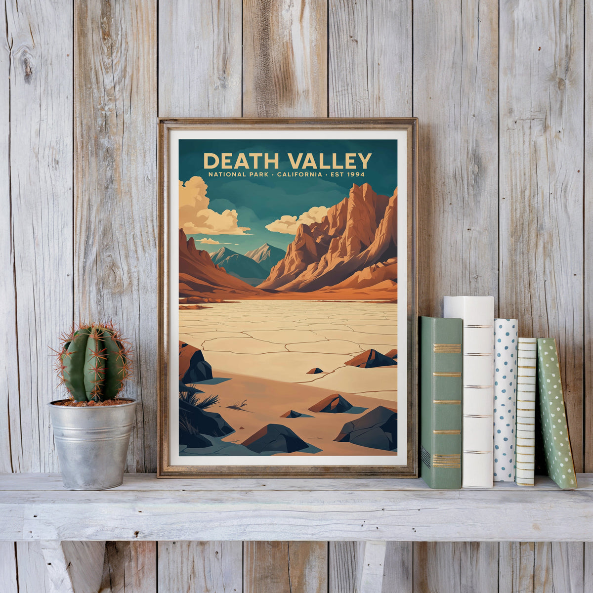 Death Valley poster in an antique gold frame against whitewashed farmhouse planks and books