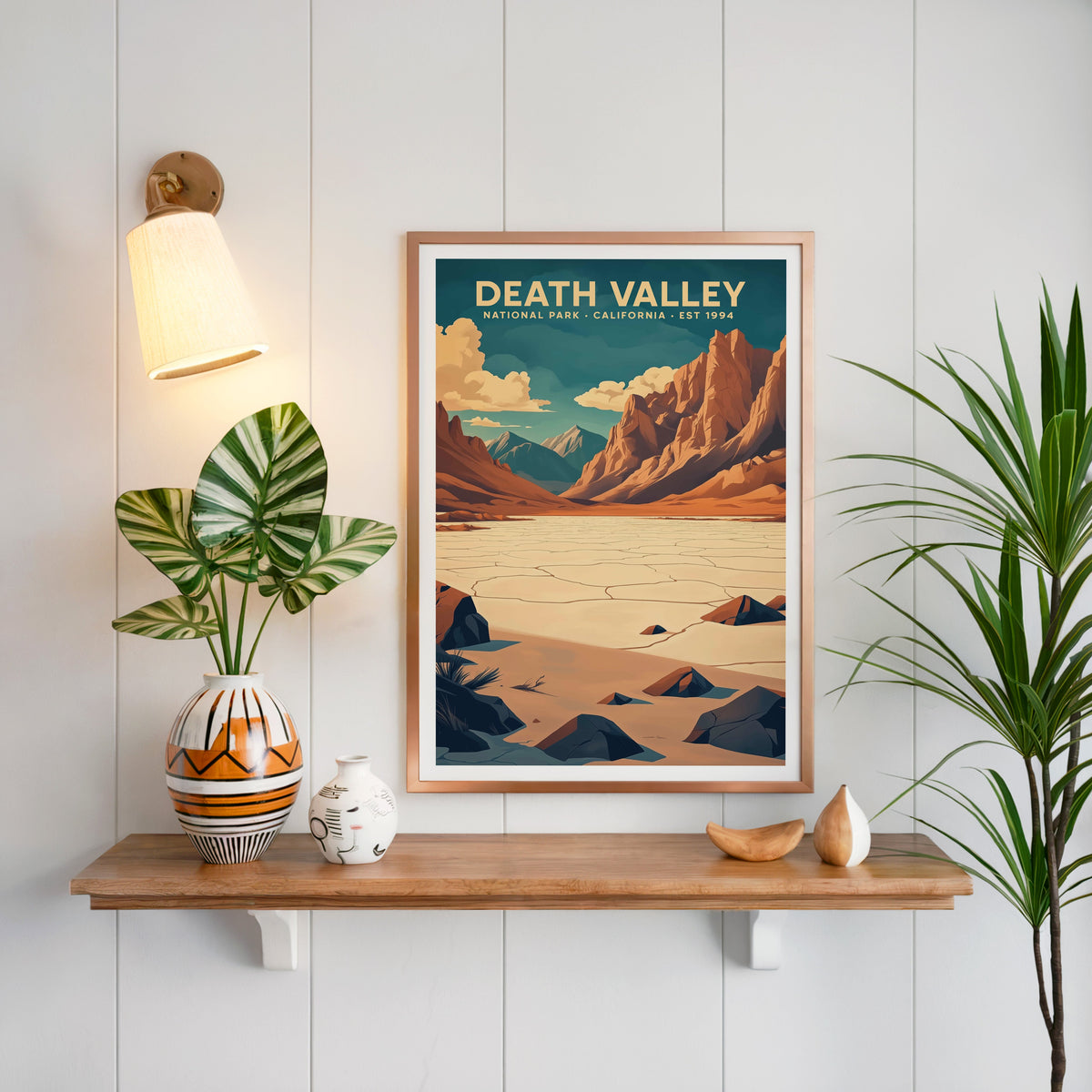 Death Valley National Park print in a copper frame above an oak shelf on white shiplap