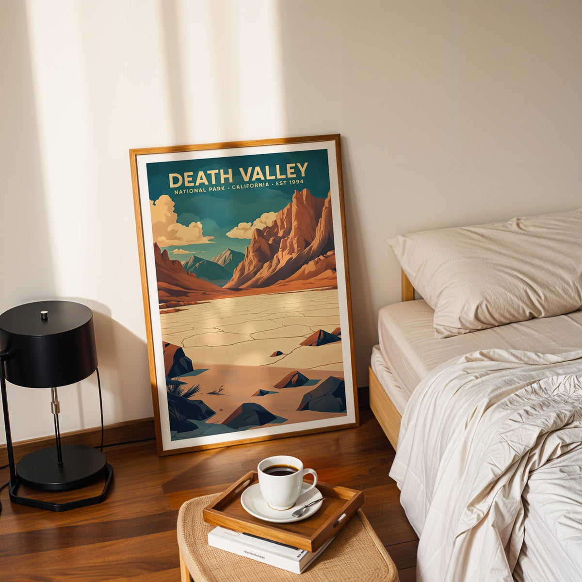 Death Valley National Park print in an oak frame leaning on a bedroom floor beside the bed