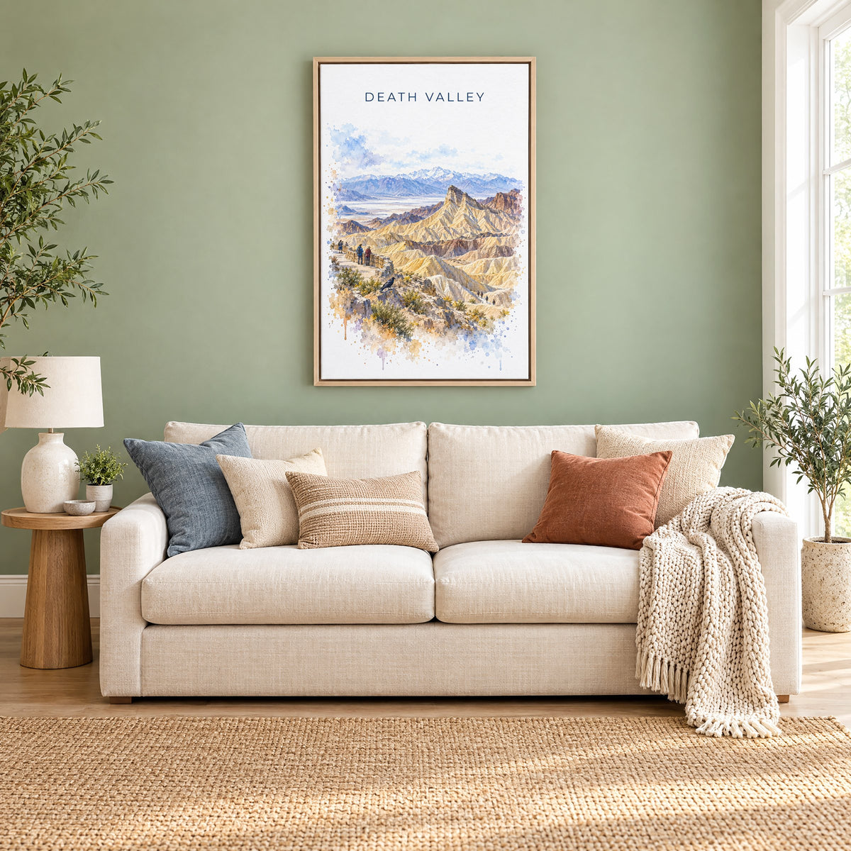 Death Valley National Park watercolor print as a natural floater canvas above a cream linen sofa on a sage green wall