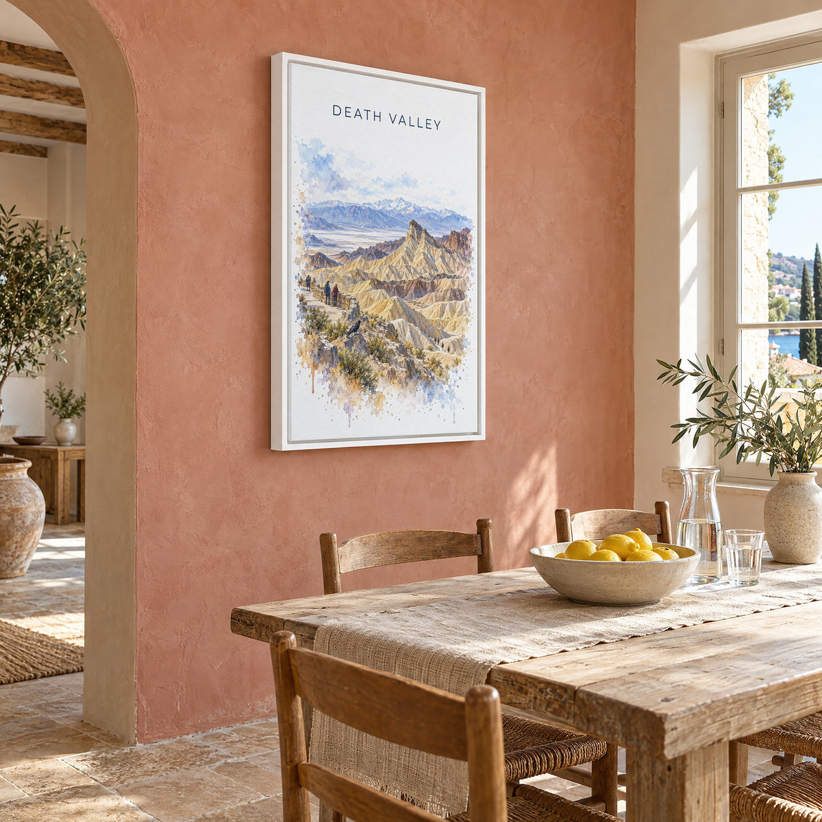 Death Valley National Park watercolor print as a white floater canvas on a terracotta wall above a rustic dining table