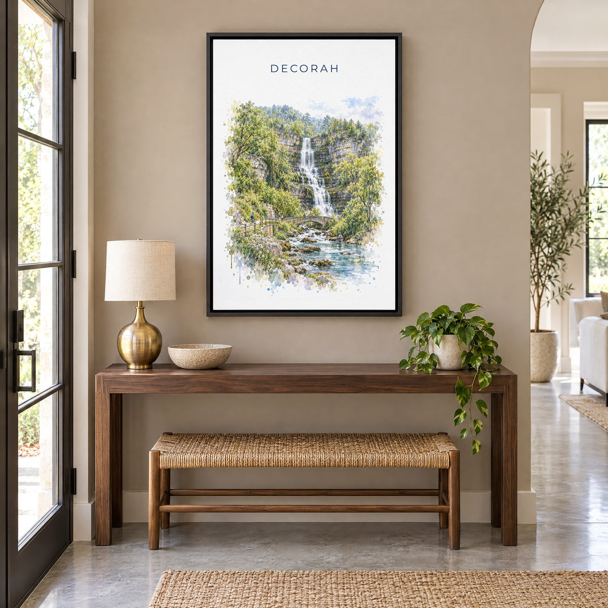 Decorah, Iowa watercolor print as a black floater canvas above a walnut console and woven bench in an entryway