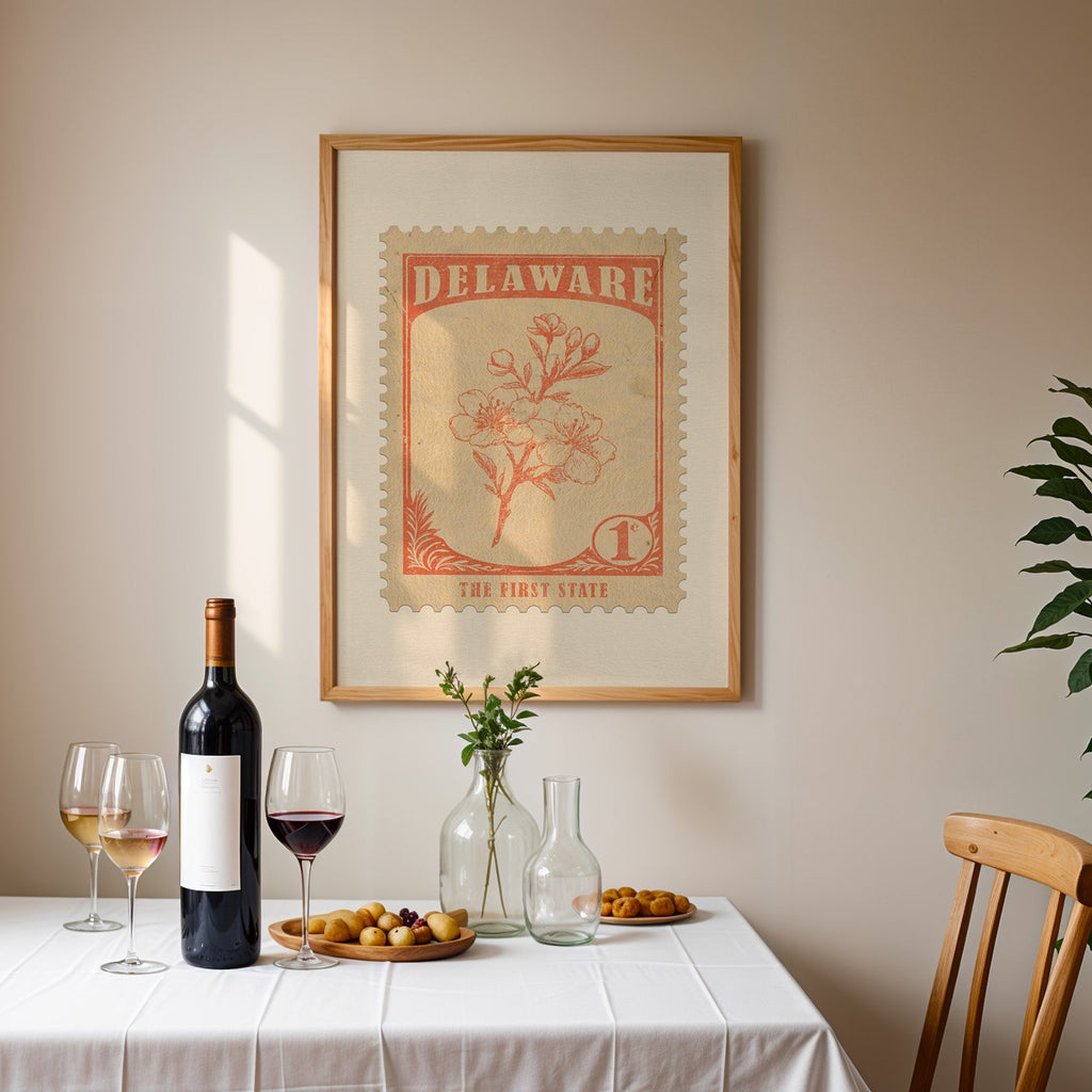 Delaware stamp print framed on the wall above a dining table set with wine, glasses and olives