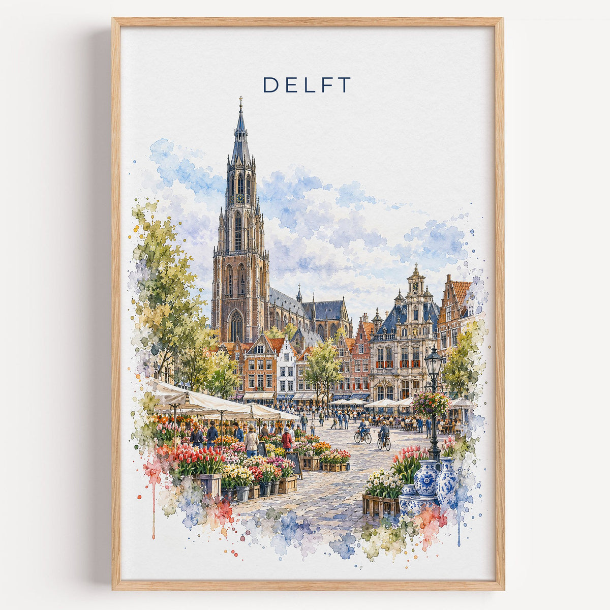 Delft watercolor print in a light oak frame on a plain white wall