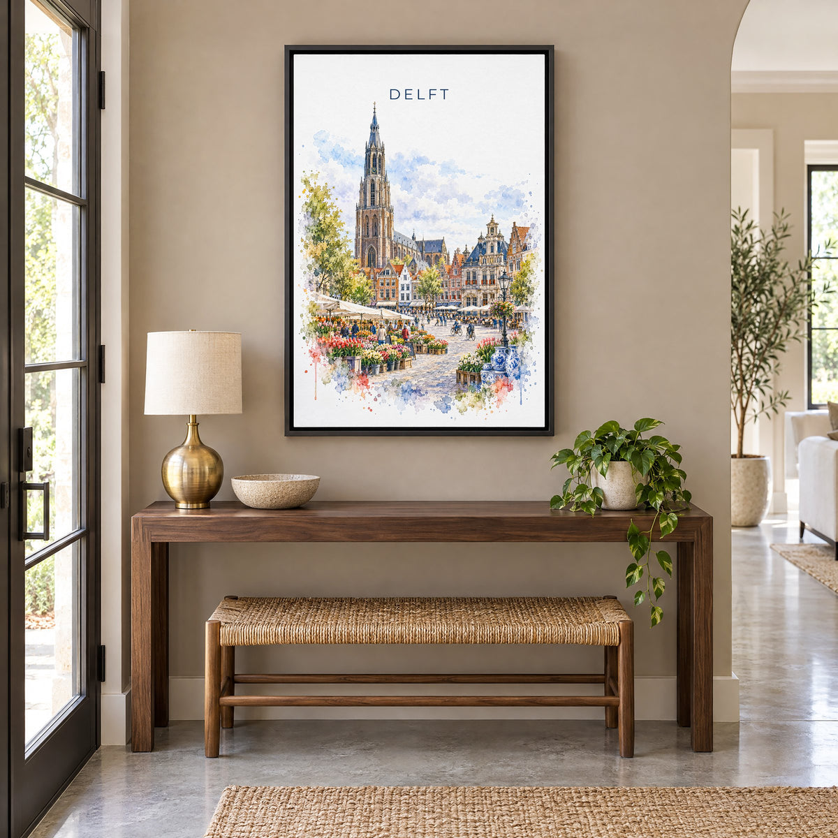 Delft watercolor print as a black floater canvas above a walnut console and woven bench in an entryway