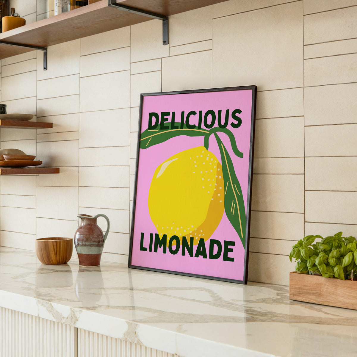 Delicious Limonade print in a black frame leaning on a marble counter in a tiled kitchen