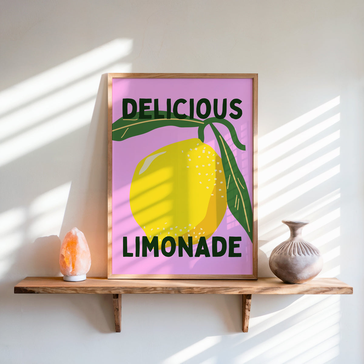 Delicious Limonade print in an oak frame on a live-edge shelf beside a salt lamp