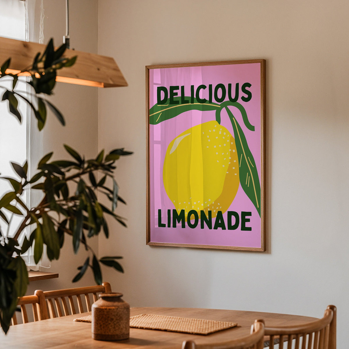 Delicious Limonade print in a walnut frame above a dining table with olive branches