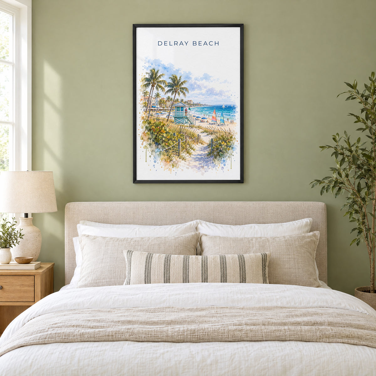 Delray Beach watercolor print in a black frame above an upholstered headboard in a sage green bedroom