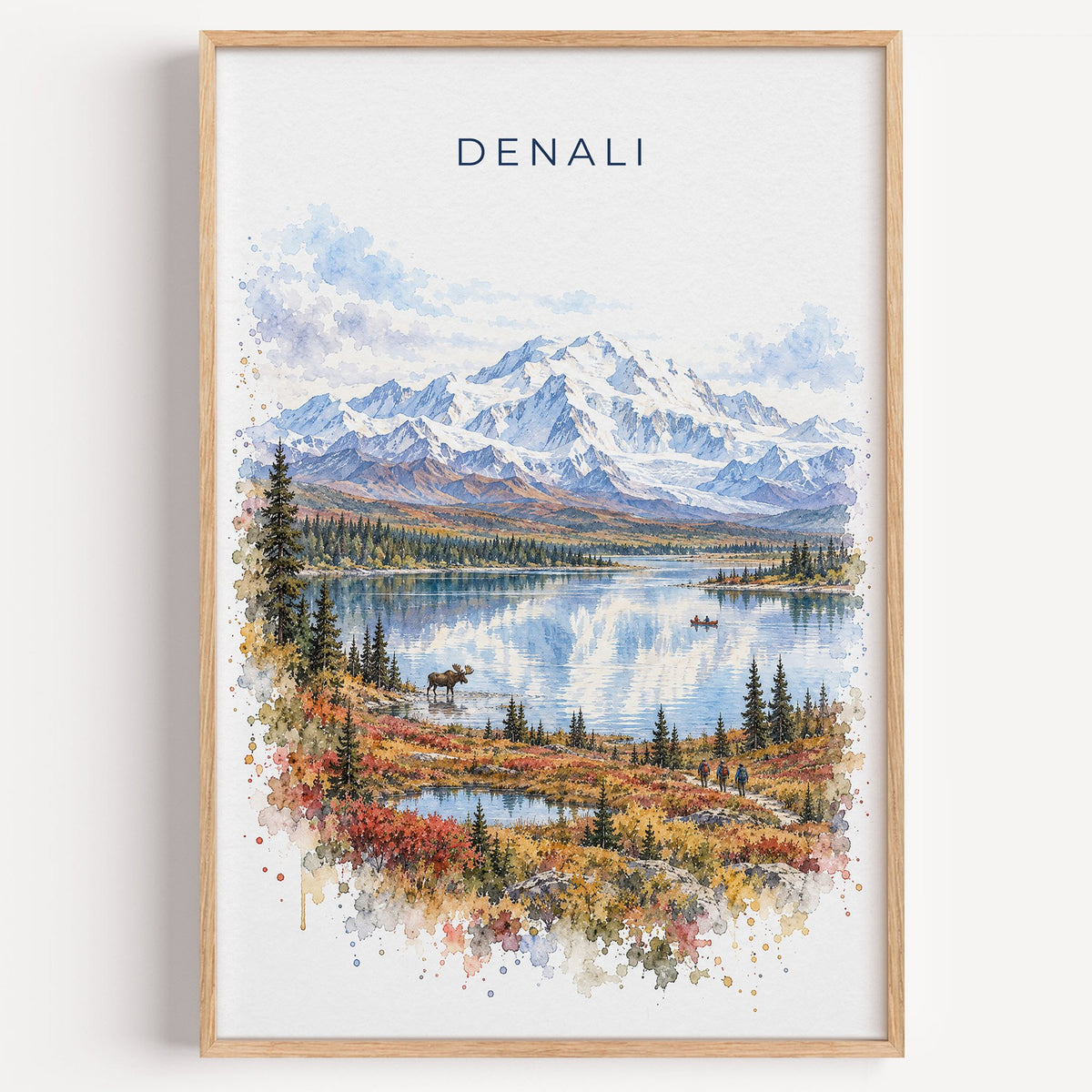 Denali National Park watercolor print in a light oak frame on a plain white wall