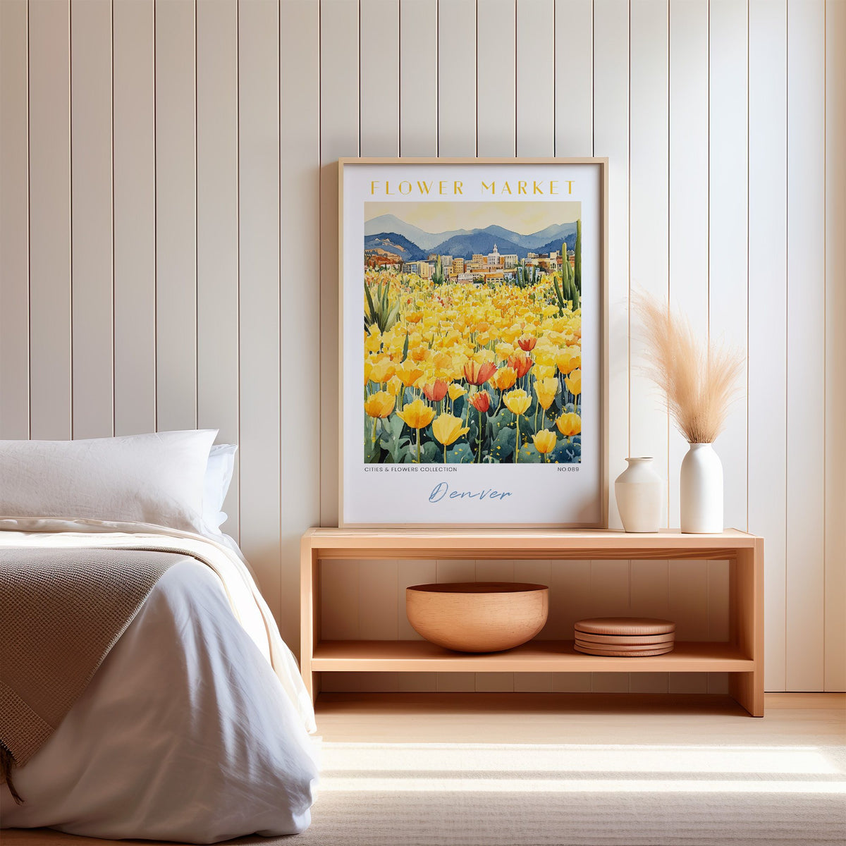 Denver flower market print in an oak frame on a wood bench against a white shiplap bedroom wall with pampas grass