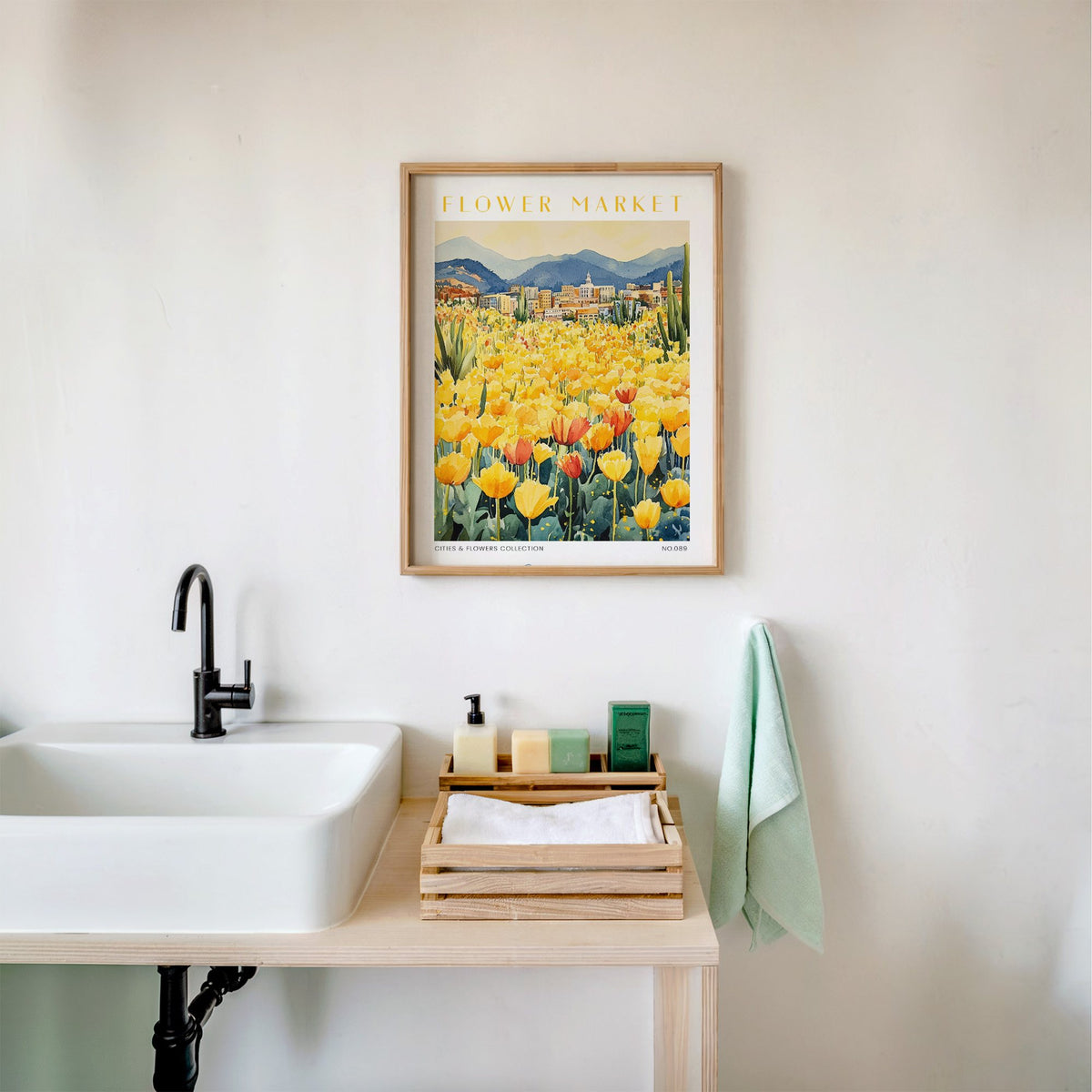 Denver flower market print in an oak frame above a white bathroom sink with folded towels
