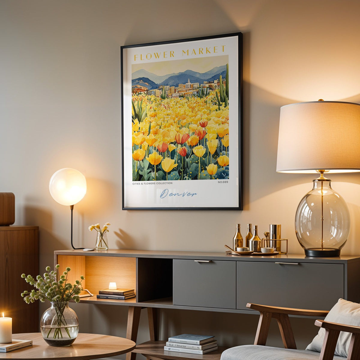 Denver flower market print in a black frame above a grey media console with a glass table lamp