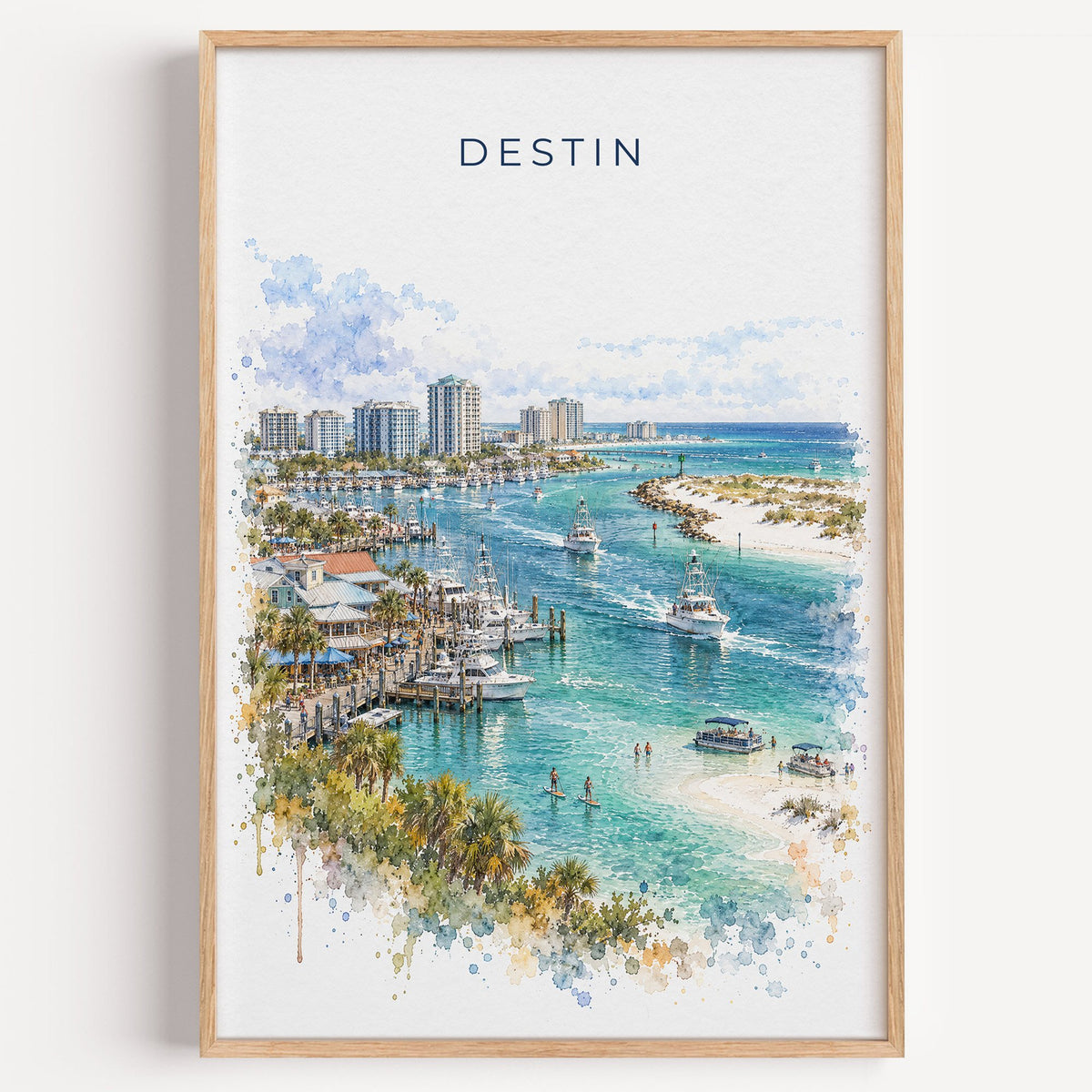 Destin watercolor print in a light oak frame on a plain white wall
