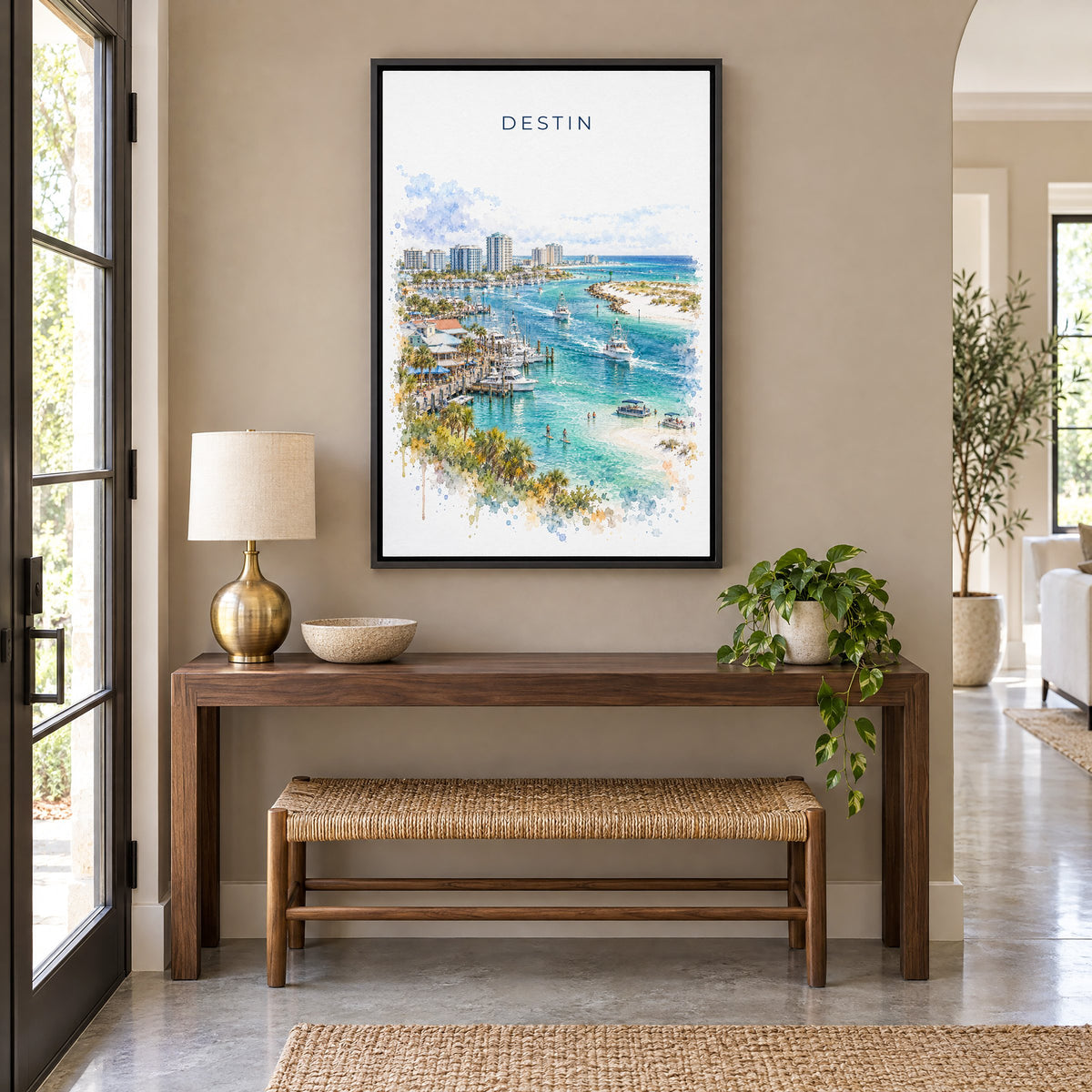 Destin watercolor print as a black floater canvas above a walnut console and woven bench in an entryway