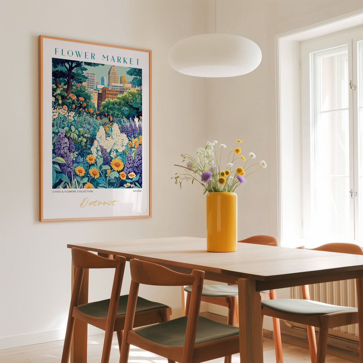 Detroit flower market print in an oak frame above a dining table with a yellow vase and white pendant light