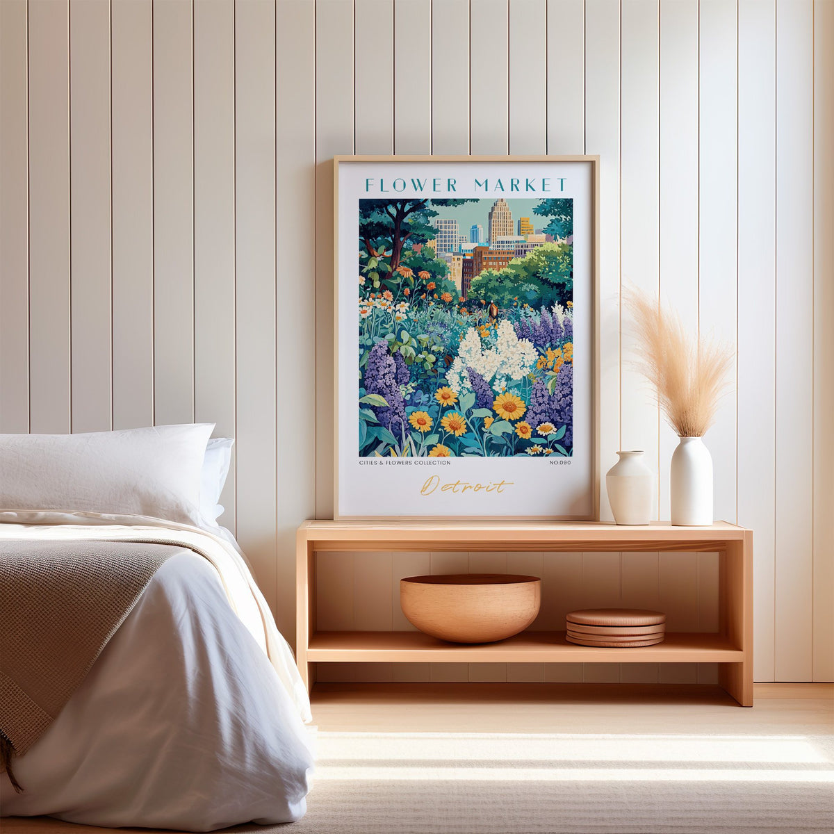 Detroit flower market print in an oak frame on a wood bench against a white shiplap bedroom wall with pampas grass