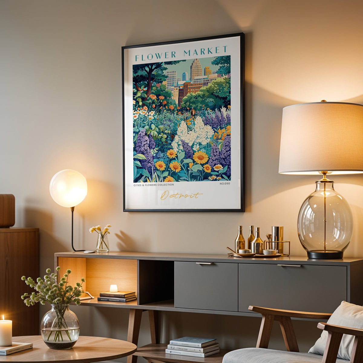 Detroit flower market print in a black frame above a grey media console with a glass table lamp