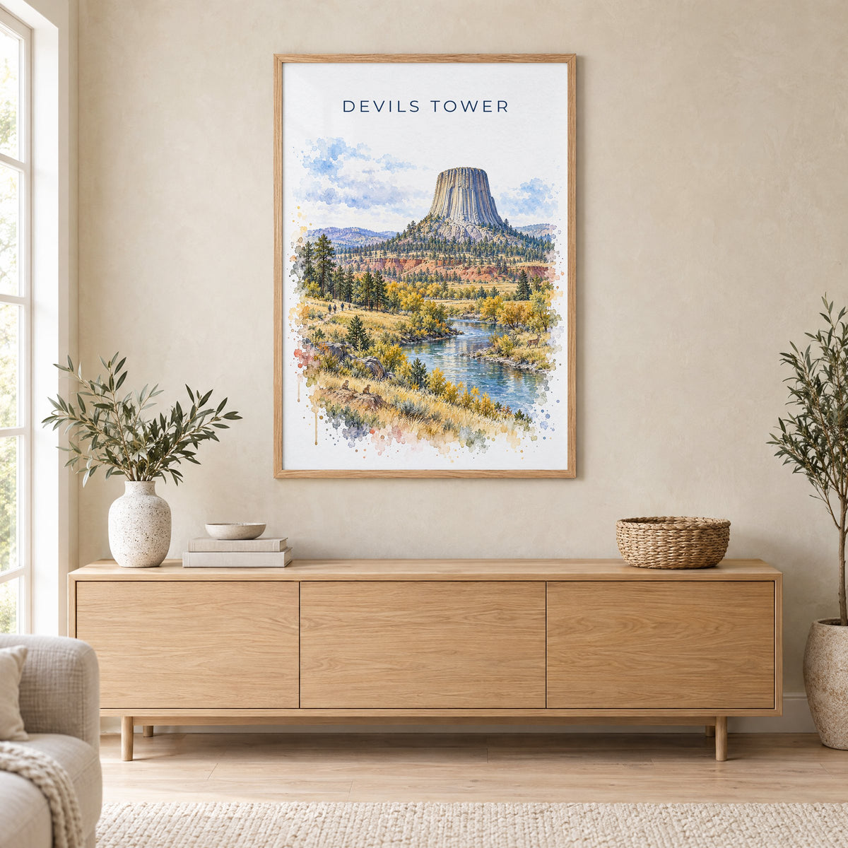 Devils Tower watercolor print in an oak frame above a light wood sideboard in a Scandinavian living room