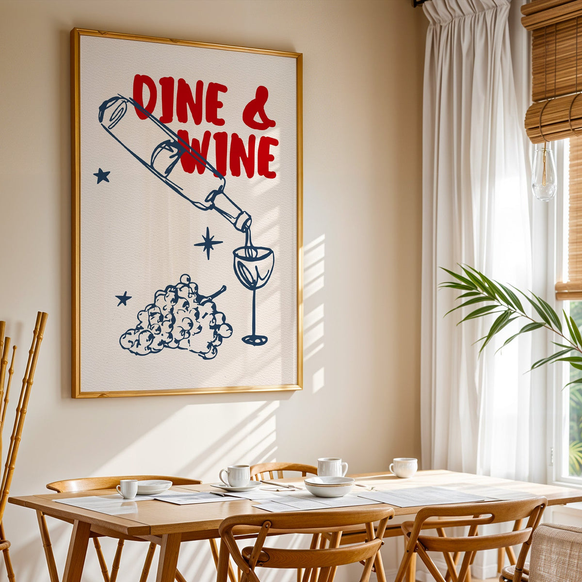 Dine and Wine print shown in a gold frame above a breakfast table by a curtained window