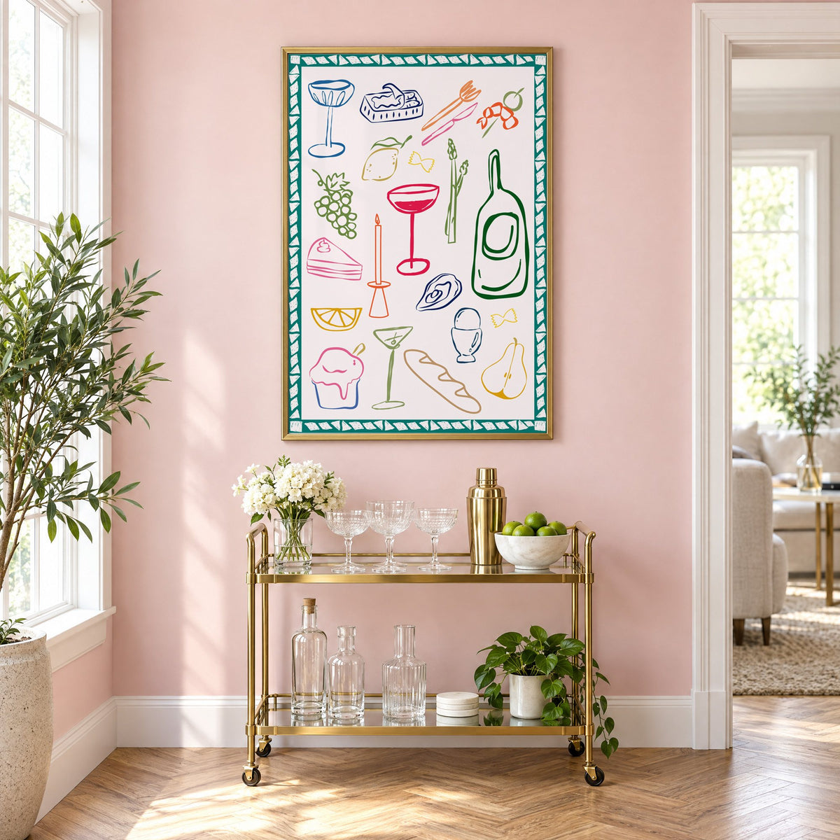 Dinner party doodles teal border print in a brass frame above a gold bar cart on a blush pink wall
