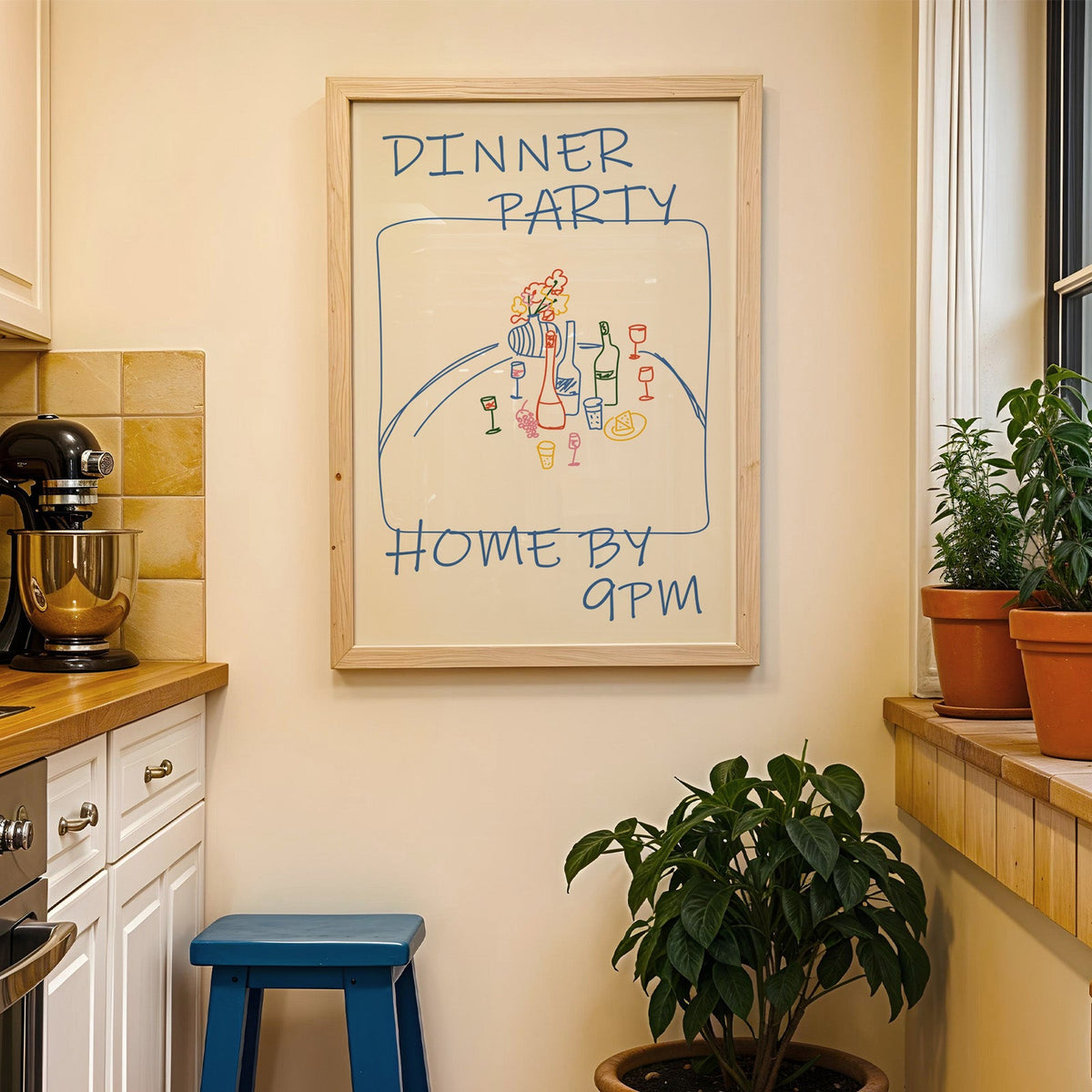 Dinner party blue line print in a wood frame on a yellow tiled kitchen wall